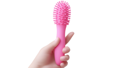 Bright pink hairbrush held in hand against a plain background showcasing its unique design and texture