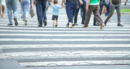 People crossing the zebra on the road.
