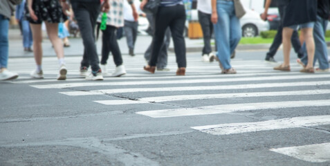 People crossing the zebra on the road.
