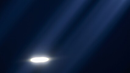 Abstract Dark Blue Background with Glowing Light Rays and Spotlight