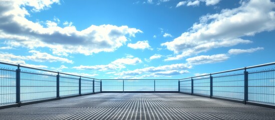 Steel grated roof with an empty perspective facing a vibrant blue sky, fluffy white clouds in the background, metal surface reflecting light.