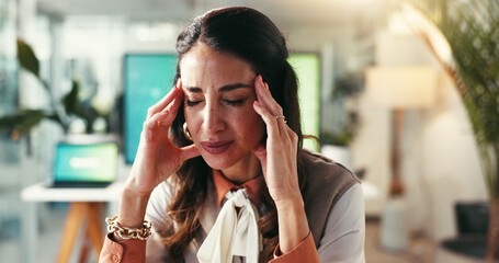 Woman, business and headache in office with stress, creativity burnout and massage temples for relief. Mature designer, migraine or pain in agency with brain fog, tension and overwhelmed with anxiety