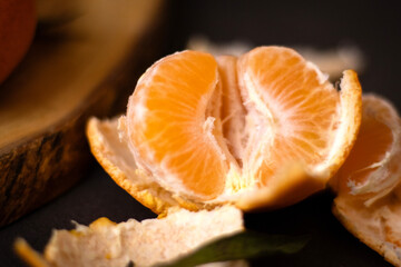Close up of peeled mandarine on wooden plate