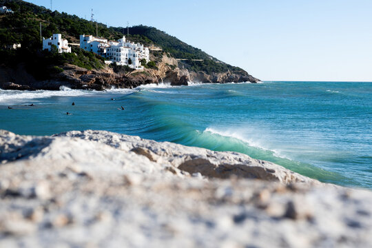 Perfect surfing wave forming near the coast on sunny day