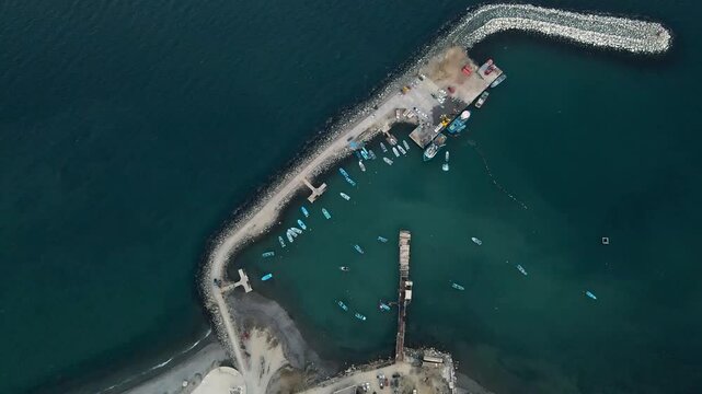 Aerial high angle overview of Cedros Island lighthouse and rocky coastline surrounded by tranquil blue waters