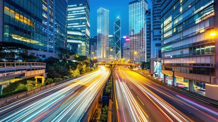 Obraz premium Light flow of traffic on a evening highway in a city with modern high buildings