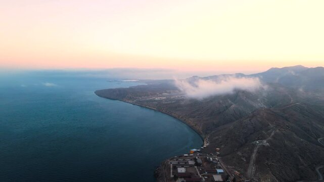 Aerial view of Cedros Island coastline at sunset, showcasing rocky terrain and ocean views