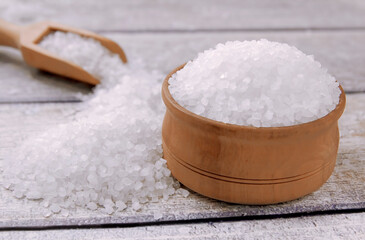 Sea salt on a wooden table. Coarse sea salt for cooking.