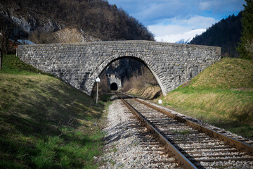 Railway track under bridge and into tunnel