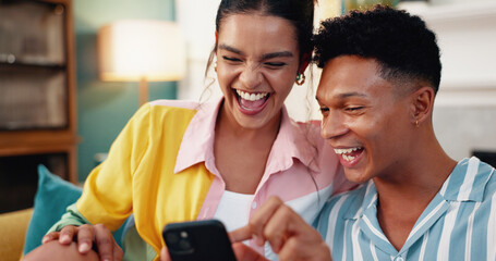 Couple, sofa and smartphone with smile, laugh and happy for web blog, movie or funny meme in living room. Man, woman and digital technology with comedy for social media post and bonding in lounge