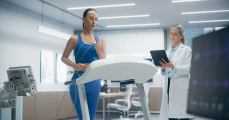 Female Athlete Performs a Cardiopulmonary Exercise Test on a Treadmill in a Modern Medical Lab,...