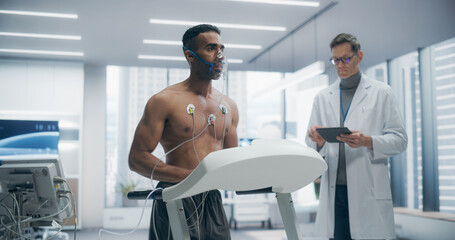 Athlete Wearing Oxygen Mask for a Treadmill Exercise Test in a Laboratory, Monitored by Sensors and...