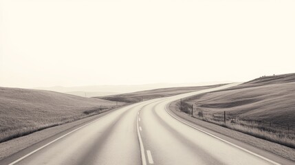 Winding road through serene countryside landscape, monochrome.