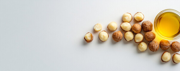 Artistic arrangement of macadamia nuts and oil on light background, showcasing natural beauty and health benefits of these ingredients
