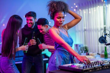 Group of diverse man and woman dancing with DJ mixing music on console. 
