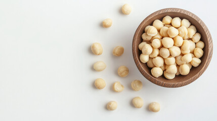 Fresh macadamia nuts in polished wooden bowl, surrounded by scattered nuts, create natural and inviting scene. Perfect for healthy snacking or culinary use