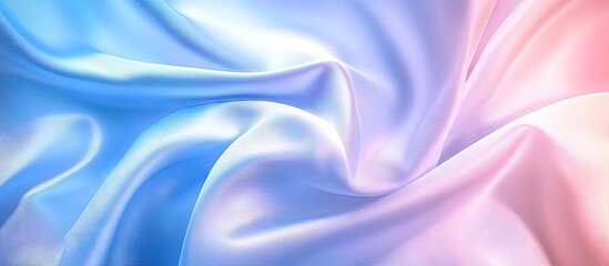 Fototapeta premium Pastel blue and pink silky fabric swirling together, creating an ethereal abstract background ideal for artistic and creative projects.