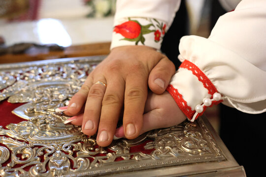 The newlyweds put their hands on the Gospel, making marriage vows.