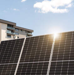 Black solar panel in front of rooftop of residential house in city