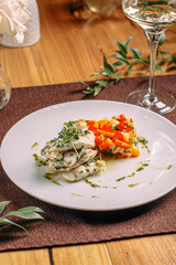 Portion of gourmet white fish with sauted vegetables