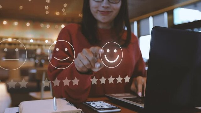 Businesswoman pressing face emoticon on the keyboard laptop online application for Customer review satisfaction feedback survey concept.


