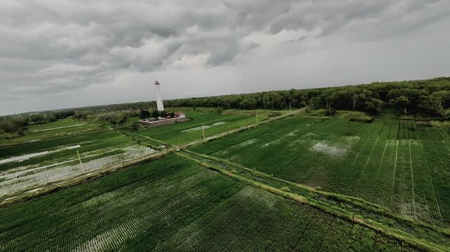 Aerial FPV drone footage of a lighthouse at Pademang Beach, Kebumen, Indonesia