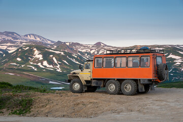 Off-road vehicle on rugged mountain terrain.