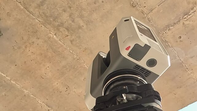 A 3D scanner is a tool for measuring. It takes measurements during the construction of tall buildings to make sure they are accurate. The scanner checks if the building is in the right place and if it