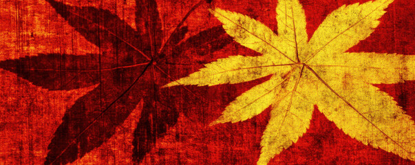 Vibrant autumn leaves in red and yellow against warm toned background create cozy atmosphere. distressed texture adds depth and character to seasonal theme