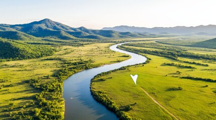 Naklejka premium Aerial view of serene river valley landscape with lush green fields and distant mountains