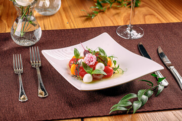 Portion of gourmet cherry tomato salad with mozzarella