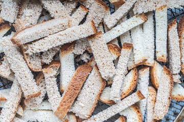 Background with the texture of slices of bread dried on a wire rack. Close-up of crackers or croutons.