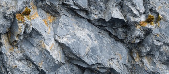 Gray textured rock surface with rough edges and subtle golden highlights, creating a natural...