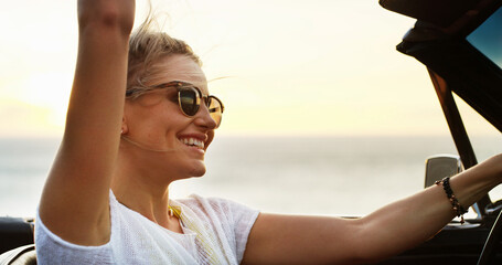Freedom, road trip and smile of woman in convertible for adventure, break or travel on blue sky....