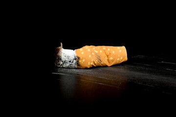 Cigarette butts isolated on black background