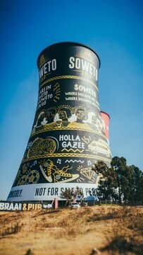 Mural on the Soweto Towers under a blue sky in South Africa.