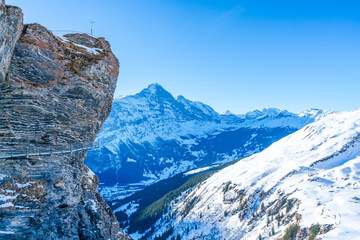 Winter landscape with snow covered peaks seen from the First mountain in Swiss Alps in Grindelwald,...