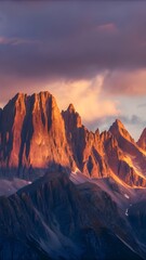 Fototapeta premium A stunning view of the Rocky Mountains at sunset, with jagged peaks glowing in orange and purple hues. 