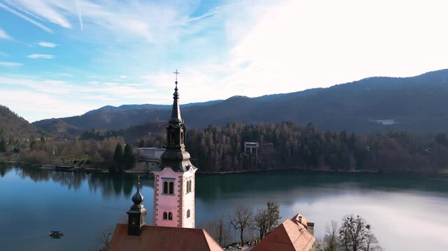 Beautiful mountains and Bled lake with small Pilgrimage Church. Bled lake and island with Church of the Assumption of Maria in winter. Bled, Slovenia. 04.01.2025