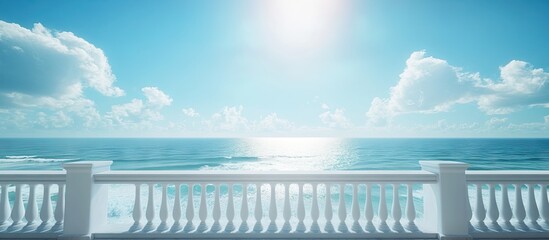 Balcony overlooking serene ocean waves under a bright blue sky with fluffy clouds creating a tranquil travel and nature ambiance