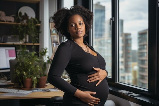 Pregnant businesswoman caressing her belly while standing in a modern office with a large window overlooking the city - Powered by Adobe