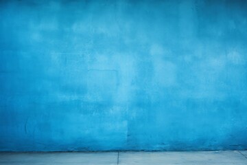 Minimalist interior design featuring a vibrant blue wall and a smooth concrete floor, creating a blank canvas for creativity