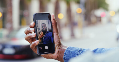 Couple, hands and city with phone screen for selfie, photography or picture in street. Closeup, man or woman with mobile smartphone display for capture moment, travel memory or app in an urban town
