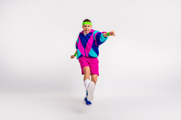 Energetic young man practising dynamic exercise in vibrant retro style against a white background