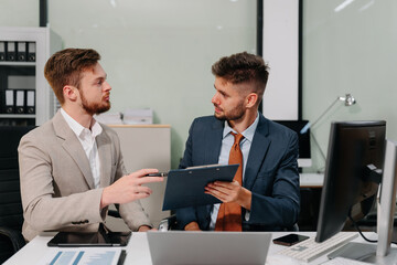 Business team working on a project in the office or reviewing and discussing a business project.