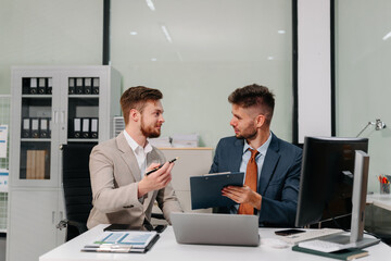 Diverse professionals collaborate on project analysis with financial graphs. Strategic teamwork and insights drive company growth and success.