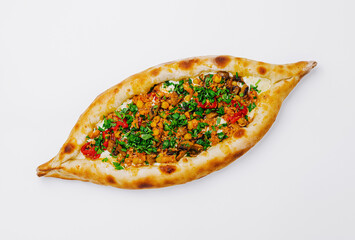Delicious pide filled with fresh vegetables and herbs served on a white background