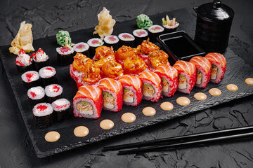 Delightful sushi platter featuring colorful rolls and fresh ingredients served on a dark slate board