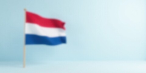 Naklejka premium A gently waving flag on a pale blue background, subtly blurred for a peaceful and serene aesthetic.