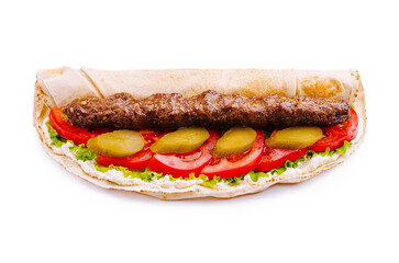 Delicious kebab wrap with fresh vegetables and sauce served on a flatbread